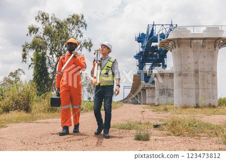 Engineer surveyor team Use drone for operator inspecting and survey construction site Engineer surveyor team Use drone for operator inspecting and survey construction site 123473812