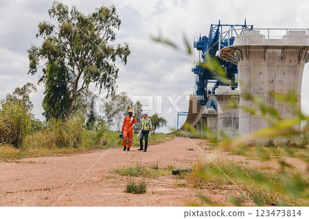Engineer surveyor team Use drone for operator inspecting and survey construction site 123473814