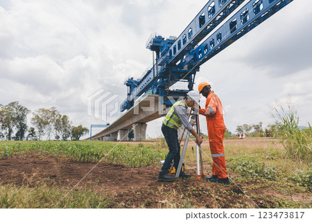 Engineer surveyor team Use drone for operator inspecting and survey construction site 123473817