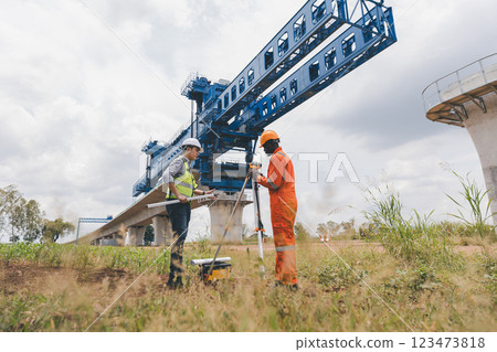 Engineer surveyor team Use drone for operator inspecting and survey construction site 123473818