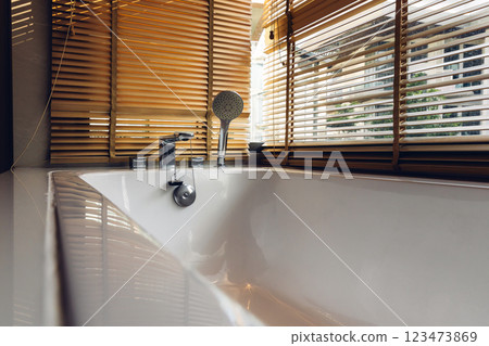 Bath tub with White foam soap bubbles. Modern ceramic bathtub	 123473869