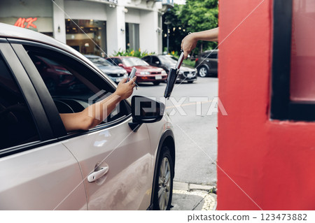 Hand Man in car receiving coffee in drive thru fast food restaurant. Hand Man in car receiving coffee in drive thru fast food restaurant. 123473882