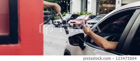 Hand Man in car receiving coffee in drive thru fast food restaurant. 123473884