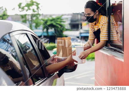 Hand Man in car receiving coffee in drive thru fast food restaurant. Hand Man in car receiving coffee in drive thru fast food restaurant. 123473888