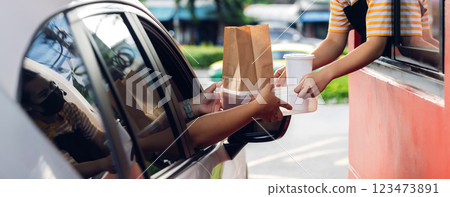 Hand Man in car receiving coffee in drive thru fast food restaurant. Hand Man in car receiving coffee in drive thru fast food restaurant. 123473891