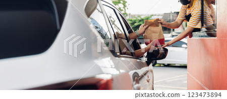 Hand Man in car receiving coffee in drive thru fast food restaurant. 123473894