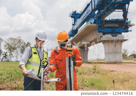 Engineer surveyor team Use drone for operator inspecting and survey construction site. 123474418