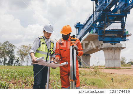Engineer surveyor team Use drone for operator inspecting and survey construction site. 123474419
