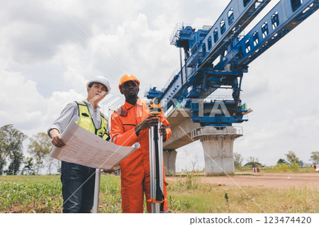 Engineer surveyor team Use drone for operator inspecting and survey construction site. 123474420