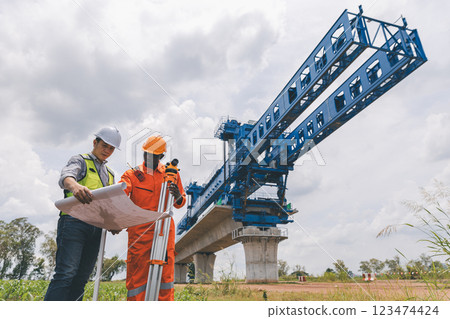 Engineer surveyor team Use drone for operator inspecting and survey construction site. 123474424