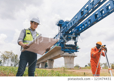 Engineer surveyor team Use drone for operator inspecting and survey construction site. 123474431