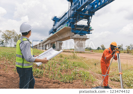Engineer surveyor team Use drone for operator inspecting and survey construction site. Engineer surveyor team Use drone for operator inspecting and survey construction site. 123474432