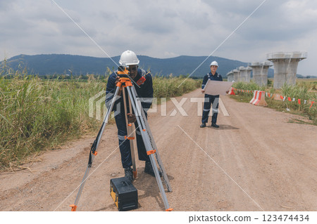 Engineer surveyor team Use drone for operator inspecting and survey construction site. 123474434