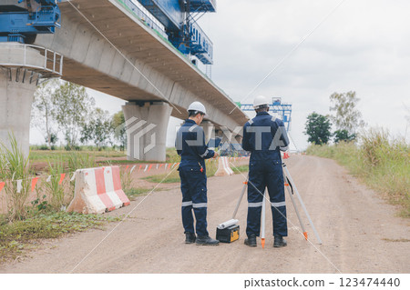 Engineer surveyor team Use drone for operator inspecting and survey construction site. 123474440