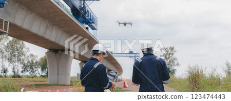 Engineer surveyor team Use drone for operator inspecting and survey construction site. 123474443