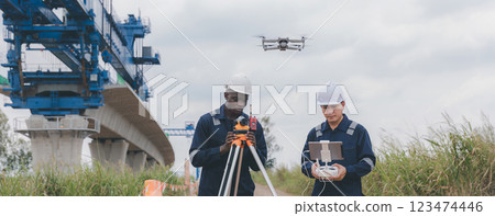 Engineer surveyor team Use drone for operator inspecting and survey construction site. Engineer surveyor team Use drone for operator inspecting and survey construction site. 123474446