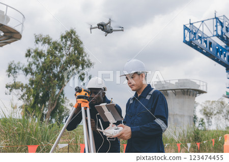 Engineer surveyor team Use drone for operator inspecting and survey construction site. Engineer surveyor team Use drone for operator inspecting and survey construction site. 123474455