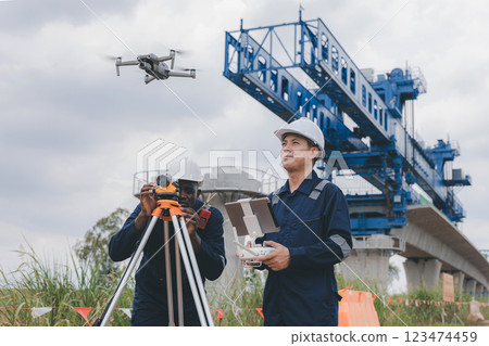 Engineer surveyor team Use drone for operator inspecting and survey construction site. Engineer surveyor team Use drone for operator inspecting and survey construction site. 123474459