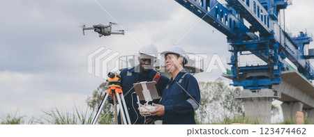 Engineer surveyor team Use drone for operator inspecting and survey construction site. 123474462