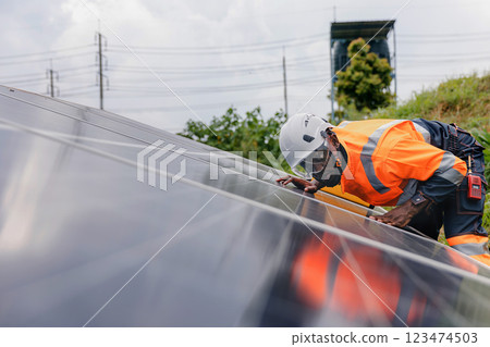 Engineer Checking solar panels in agriculture farm land. Engineer Checking solar panels in agriculture farm land. 123474503