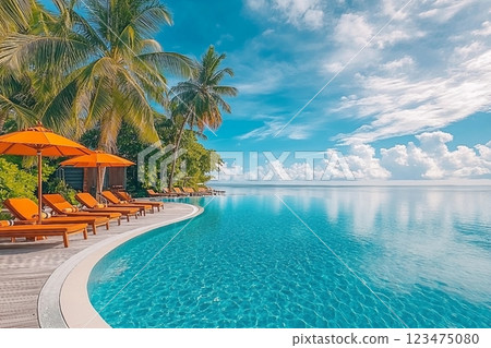 Stunning landscape, swimming pool blue sky with clouds. Tropical resort hotel in Maldives. Fantastic relax and peaceful vibes, chairs, loungers under umbrella and palm leaves. Luxury travel vacation Stunning landscape, swimming pool blue sky with clouds. Tropical resort hotel in Maldives. Fantastic relax and peaceful vibes, chairs, loungers under umbrella and palm leaves. Luxury travel vacation 123475080