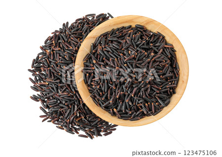 Black wild rice in wooden bowl isolated on white background close up. Top view. Flat lay Black wild rice in wooden bowl isolated on white background close up. Top view. Flat lay 123475106