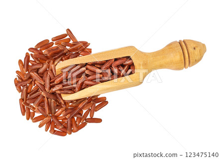 red rice in a wooden scoop isolated on white background. Top view. Flat lay 123475140