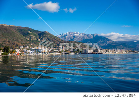 Bay of Kotor in Montenegro and the top of high snow-capped mountains, small settlements on the coast and the bright blue waters of the Adriatic Sea. 123475894