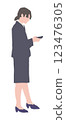 A woman in a suit looking at her smartphone 123476305