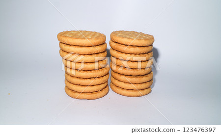 Chocolate biscuit round snacks stacked on a white background 123476397