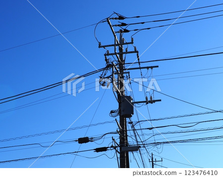 A steel tower that stands out against the blue sky. The art of wires and the sky. I am fascinated by the refreshing blue. 123476410