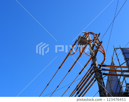 A steel tower that stands out against the blue sky. The art of wires and the sky. I am fascinated by the refreshing blue. A steel tower that stands out against the blue sky. The art of wires and the sky. I am fascinated by the refreshing blue. 123476451