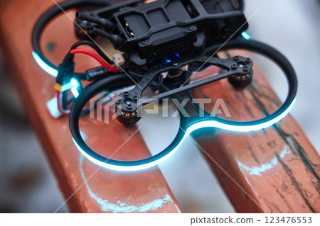 FPV drone with blue LED lighting around the perimeter of the frame, motors on 123476553