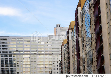 A long row of impressive tall buildings set against a clear blue sky 123476582