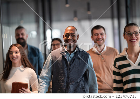Business team in a modern open space startup office walking together. Diverse group of businesspeople smiling while having a discussion. Successful mixed race colleagues collaborating on a new project Business team in a modern open space startup office walking together. Diverse group of businesspeople smiling while having a discussion. Successful mixed race colleagues collaborating on a new project 123476715