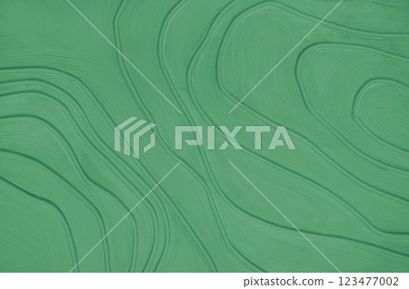 Plaster wall with volumetric relief surface with convex wavy lines, green gypsum texture panel. Plaster wall with volumetric relief surface with convex wavy lines, green gypsum texture panel. 123477002