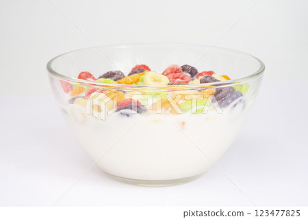 Delicious and nutritious fruit cereal loops multicolored flavorful on white background, healthy and funny addition to kids breakfast Delicious and nutritious fruit cereal loops multicolored flavorful on white background, healthy and funny addition to kids breakfast 123477825