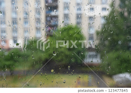 Wet rain drops on window glass season mood natural 123477845