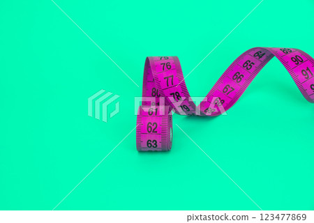 Spiral tape measure colorful background with copyspace Spiral tape measure colorful background with copyspace 123477869