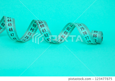 Spiral tape measure colorful background with copyspace 123477875