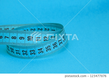 Blue tape measure diet concept on background with copyspace 123477876