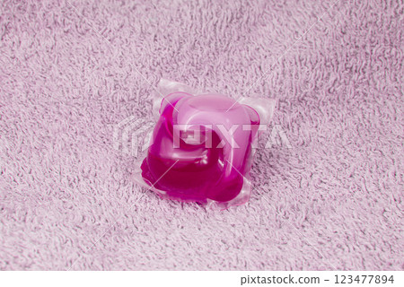 Washing gel capsule on material textile background 123477894