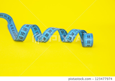 Spiral tape measure colorful background with copyspace 123477974