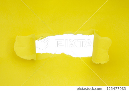 Yellow torn paper hole craft concept background Yellow torn paper hole craft concept background 123477983