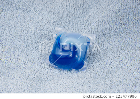 Washing gel capsule on material textile background 123477996