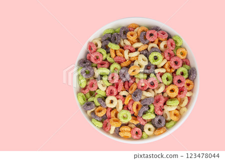Delicious and nutritious fruit cereal loops multicolored flavorful on white background, healthy and funny addition to kids breakfast Delicious and nutritious fruit cereal loops multicolored flavorful on white background, healthy and funny addition to kids breakfast 123478044