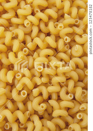 Cavatappi dry pasta organic product background yellow 123478182