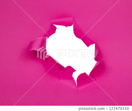 Hole in paper pink background torn damaged for design 123478330