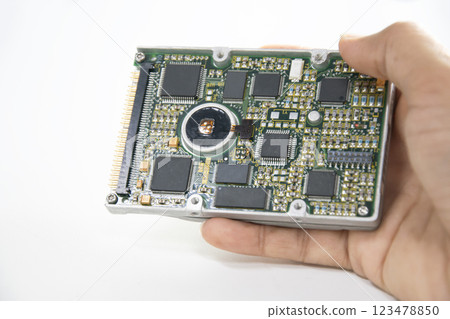 2.5 inch hard disk. Technician holding hard disk on white background. 123478850