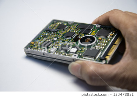 2.5 inch hard disk. Technician holding hard disk on white background. 123478851